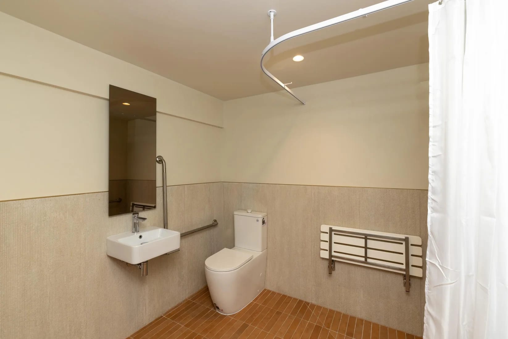 Accessible bathroom with shower, grab rails and fold-down seat at Thinkspace Grafton