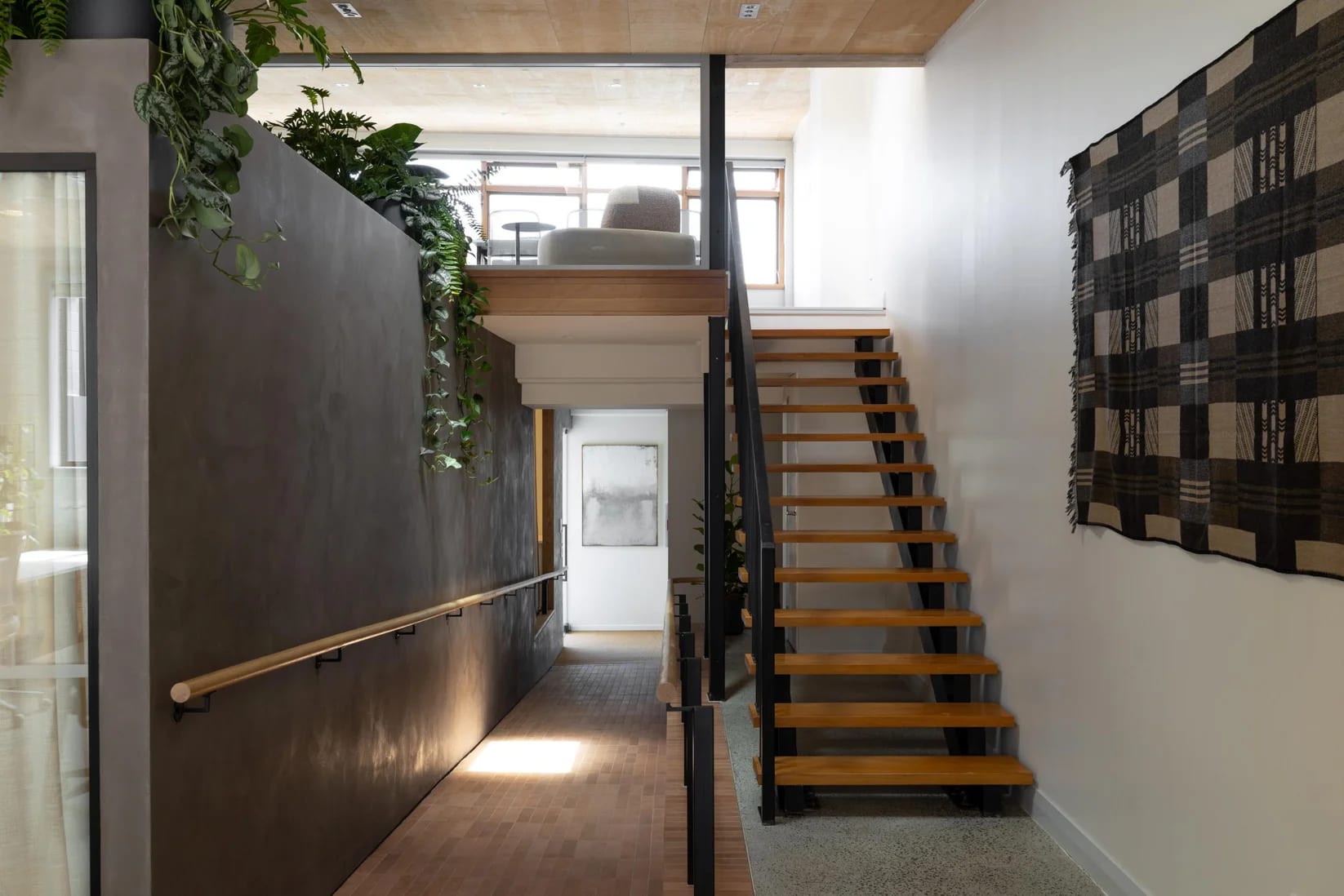 Timber and steel stair rising to the mezzanine breakout at Thinkspace Grafton