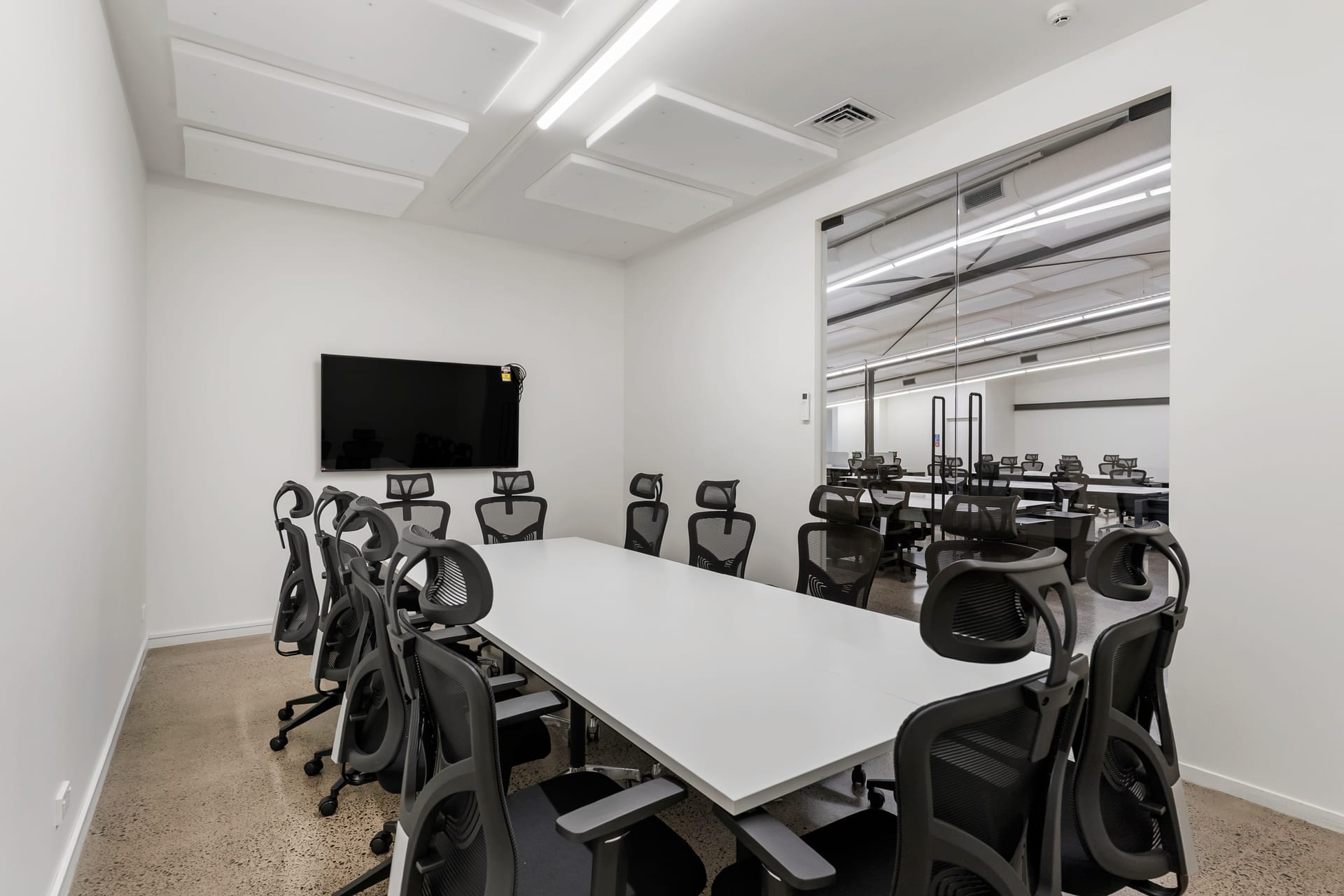 Boardroom with glass wall overlooking the open-plan floor at Thinkspace Morningside