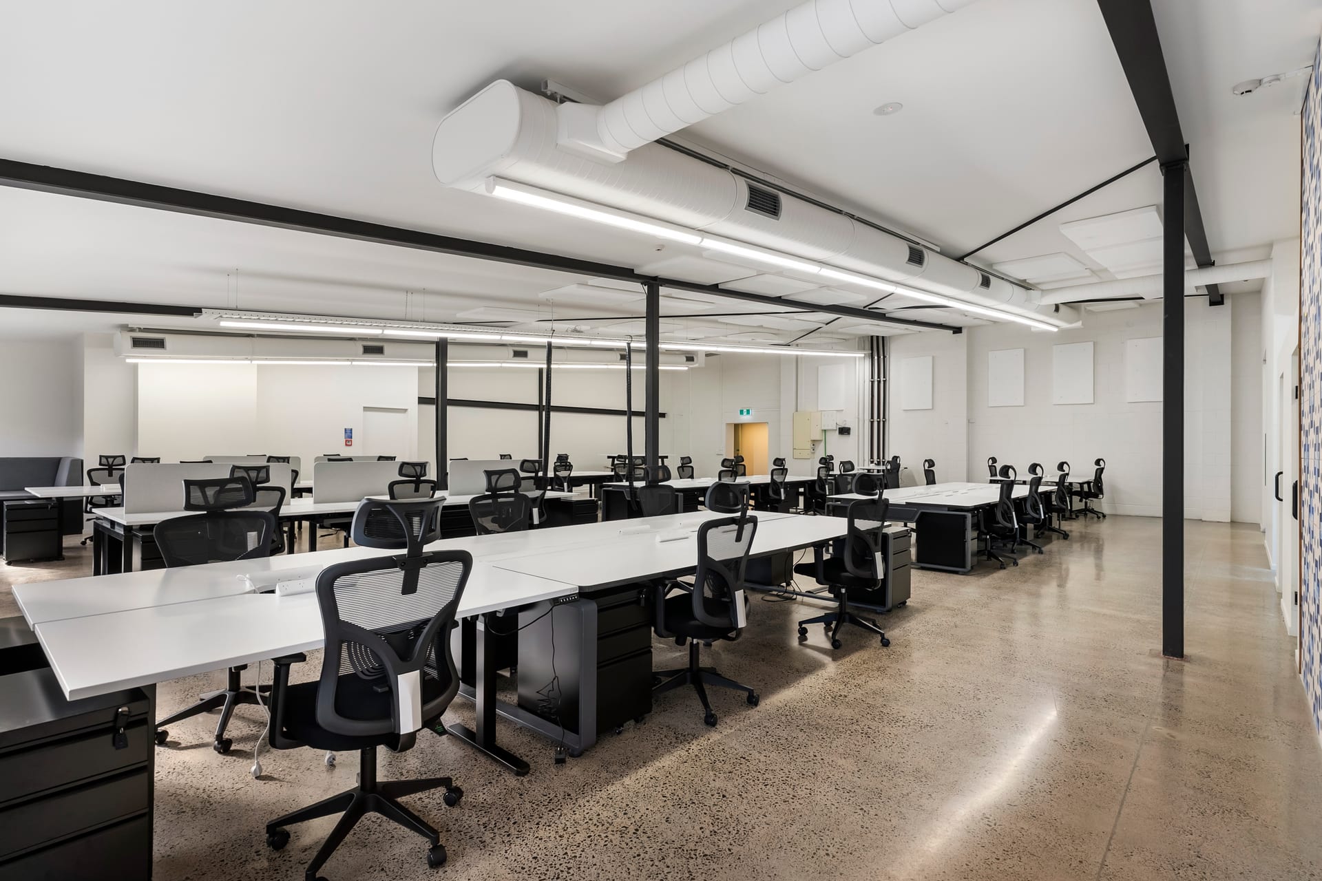 Rows of ergonomic dedicated desks with mobile storage at Thinkspace Morningside