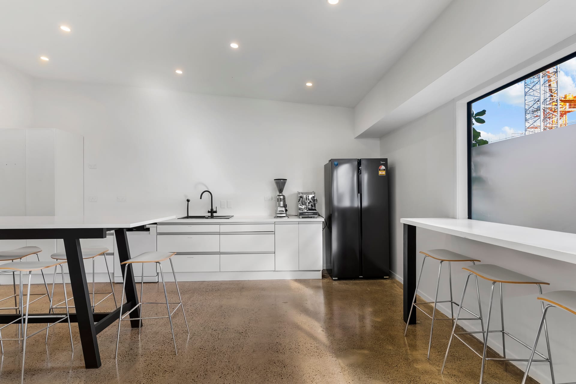 Full kitchen with espresso machine, fridge and leaner seating at Thinkspace Morningside