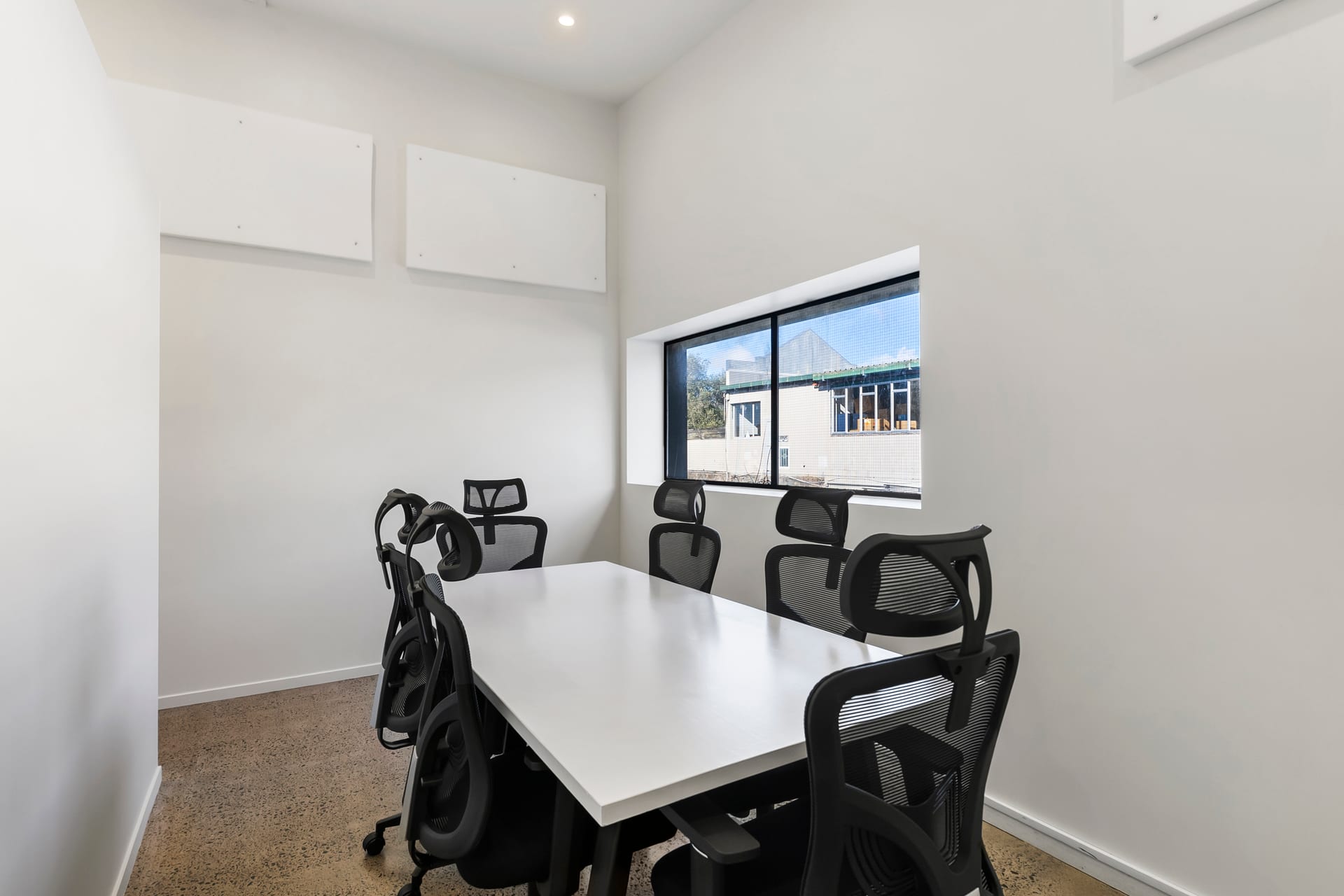 Private six-person meeting room with natural light at Thinkspace Morningside