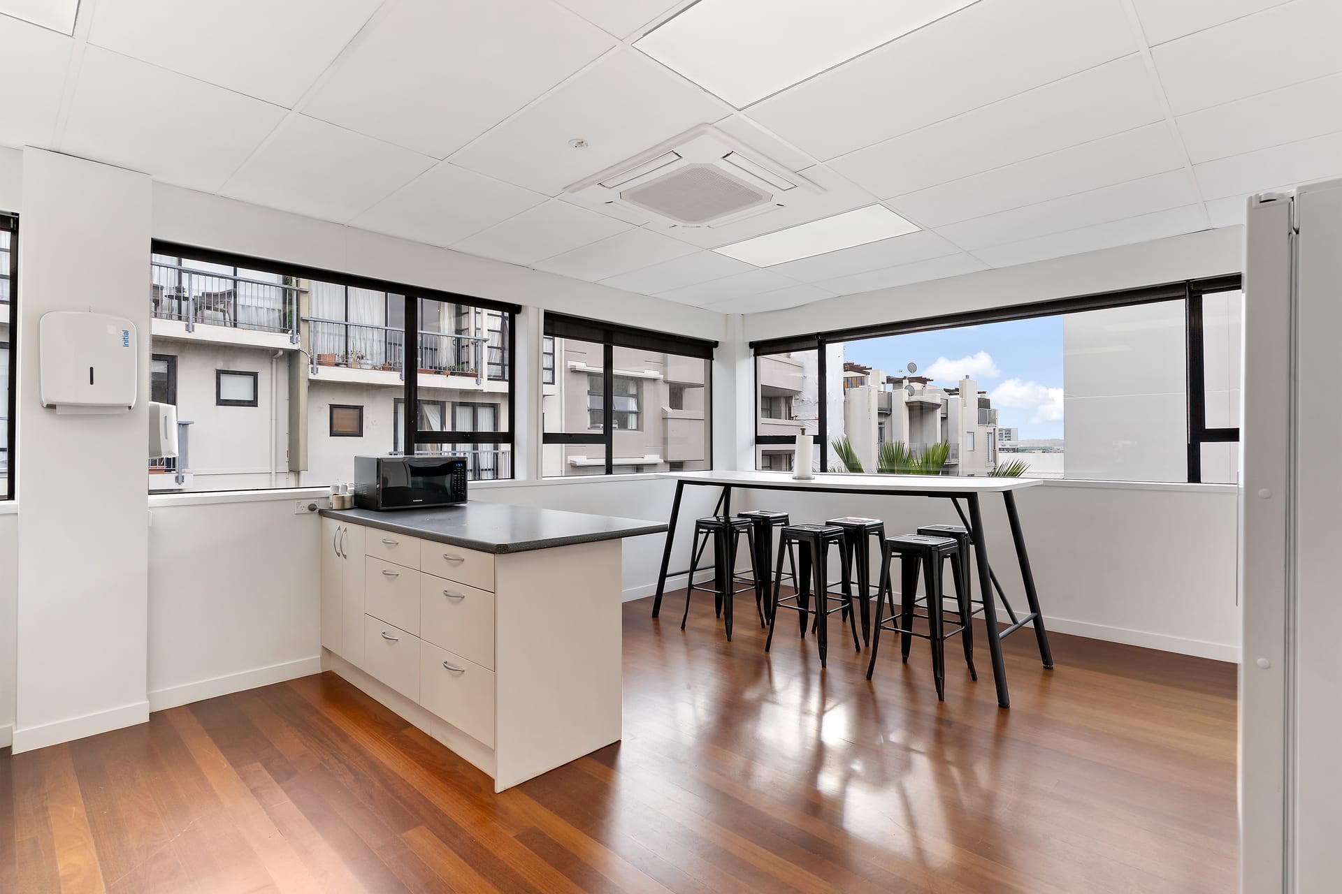 Kitchen and breakout area with leaner seating and city views at Thinkspace Parnell