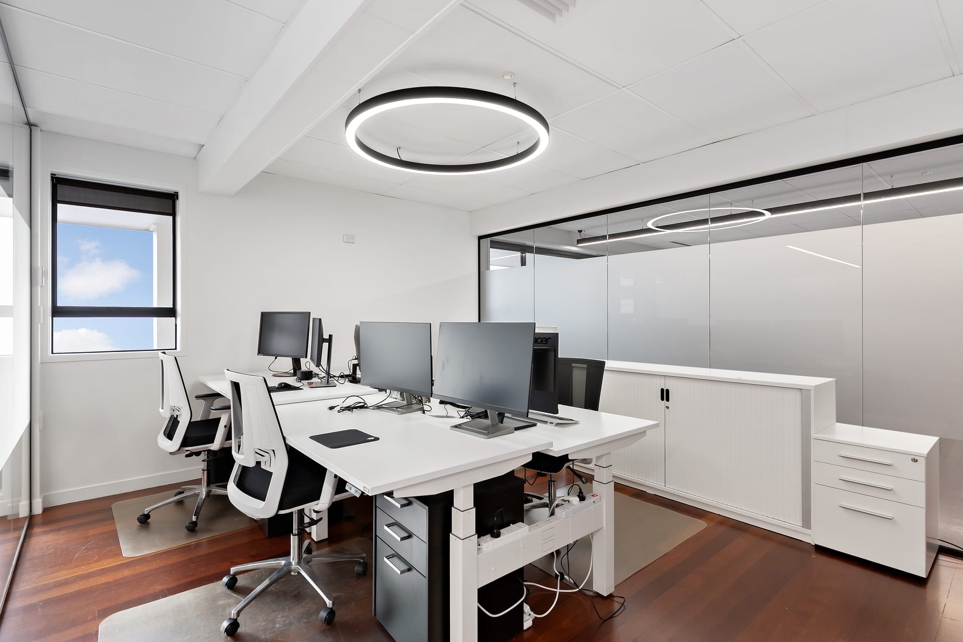 Modern private office with ergonomic sit-stand workstations at Thinkspace Parnell