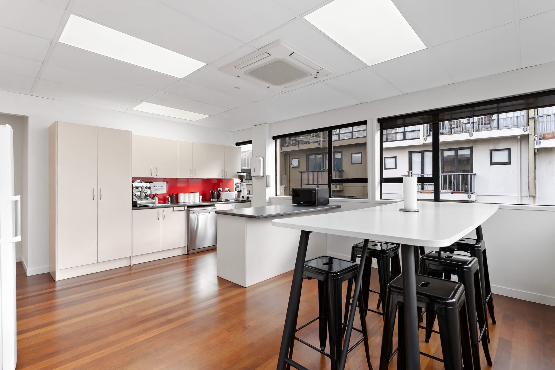 Fully equipped shared kitchen with breakfast bar at Thinkspace Parnell